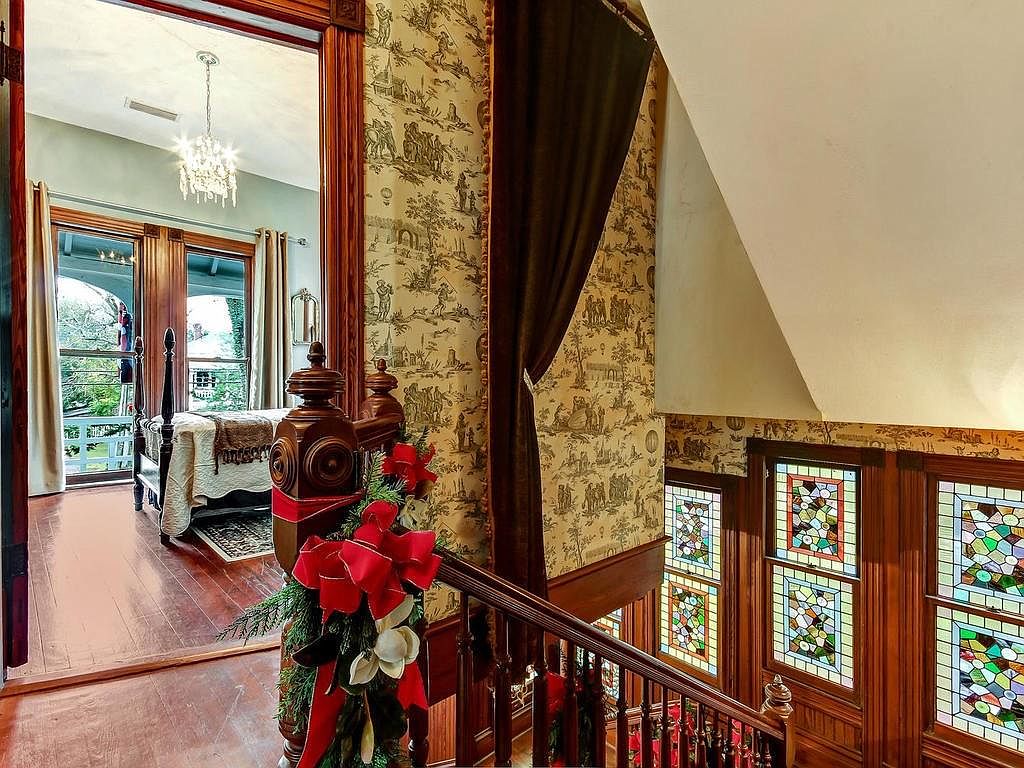 Upper landing with stained glass windows and mahogany banister