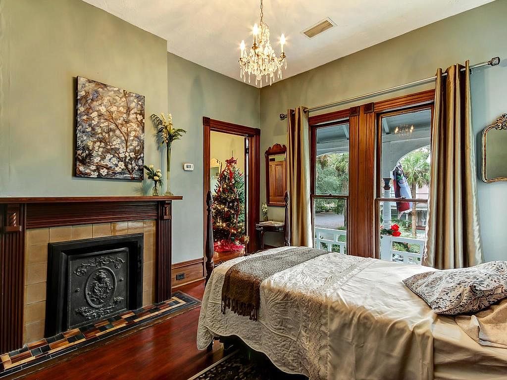 Bedroom with ornamental cast iron fireplace surround and crystal chandelier