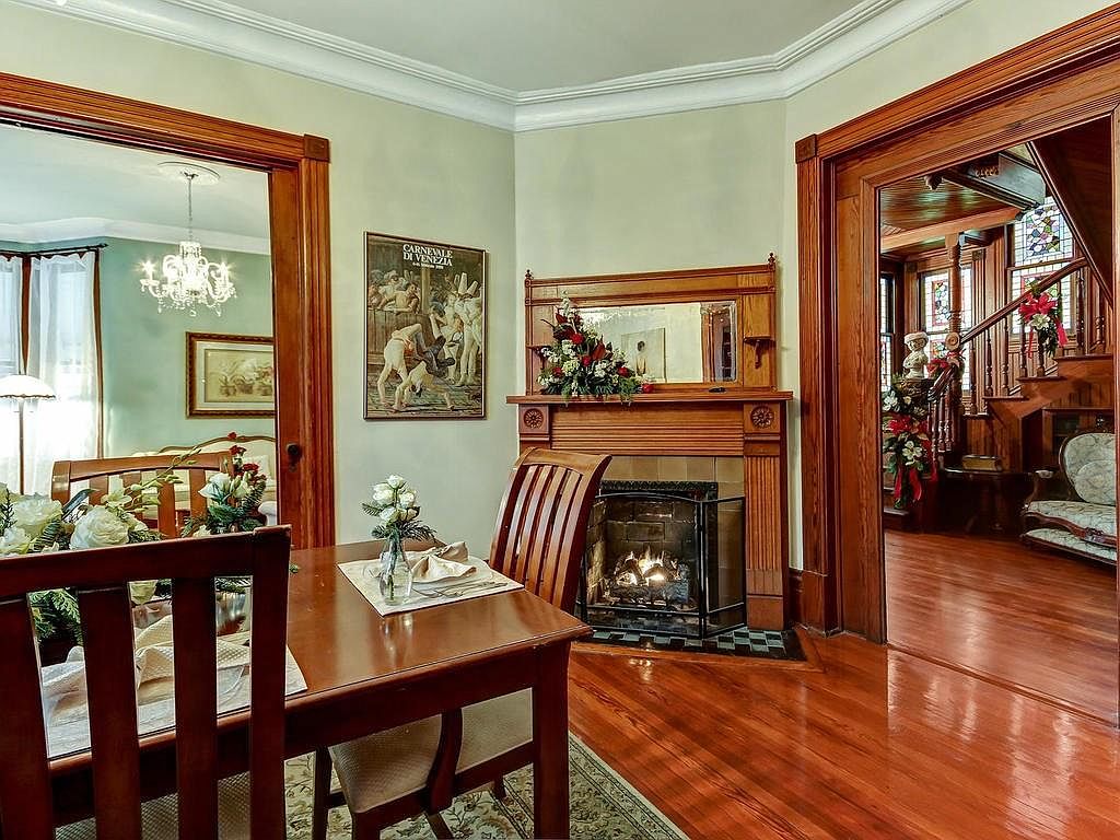 Sitting room with original fireplace surround and pocket doors